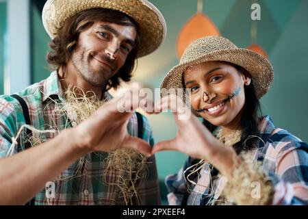 Home is where my heart is. a young couple making a heart gesture with their hands at home. Stock Photo