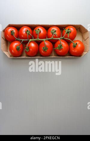 Cherry tomatoes in ecological cardboard box Stock Photo