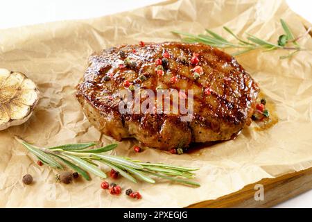 Fried steak close up, tasty, restaurant. Spiced with peppercorns and herbs Stock Photo