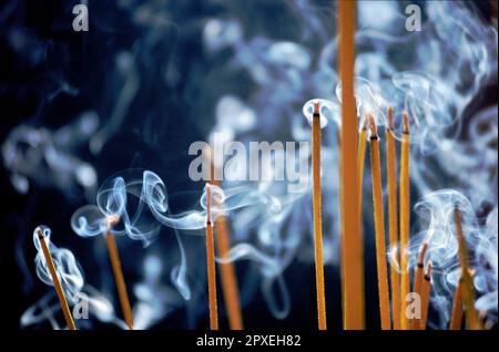 Scanned slide of historical color photograph showing smoke from incense sticks inside a Buddhist pagoda in Saigon, Vietnam Stock Photo