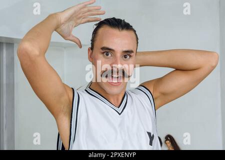 young gender non-binary Latina dressed as a drag queen, standing