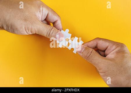 Perfect Match. Two Hands Holding Matching Puzzle Pieces. Stock Photo