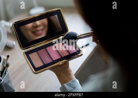 Beauty blogger use brush with blush on to applying product for reviewing cosmetic in makeup vlogger. Stock Photo