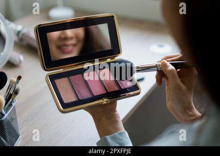 Beauty blogger use brush with blush on to applying product for reviewing cosmetic in makeup vlogger. Stock Photo