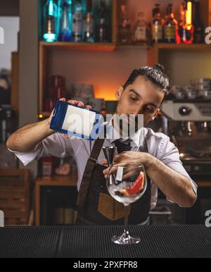 https://l450v.alamy.com/450v/2pxfpr8/professional-bartender-pours-blue-syrup-into-a-measuring-cup-2pxfpr8.jpg