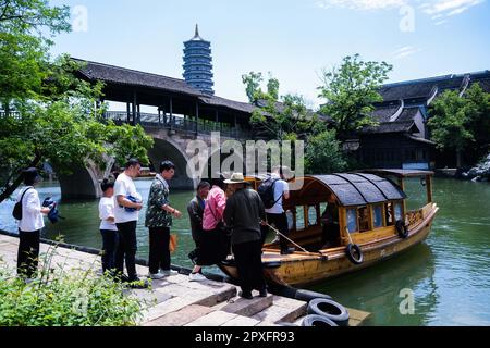 Tongxiang, China's Zhejiang Province. 2nd May, 2023. Tourists get on a boat at Puyuan Fashion Resort in Puyuan Town of Tongxiang City, east China's Zhejiang Province, May 2, 2023. Puyuan Fashion Resort receives nearly 20,000 tourists every day during this year's May Day holiday. The resort opened to the public on March 1. Credit: Xu Yu/Xinhua/Alamy Live News Stock Photo