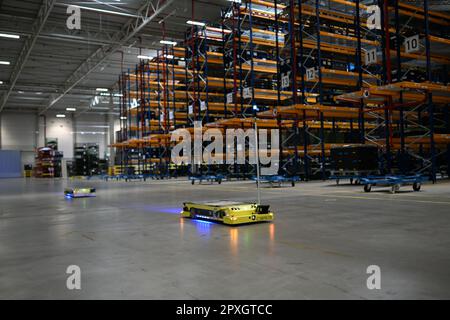 Bremen, Germany. 02nd May, 2023. A driverless transport system (AGV) is used in the BLG logistics center C3. BLG intends to bundle the international supply of the Mercedes plants in the 82,000 square meter building. Thanks to a solar system on almost the entire roof area, the logistics center is largely self-sufficient in electricity. Credit: Lars Klemmer/dpa/Alamy Live News Stock Photo