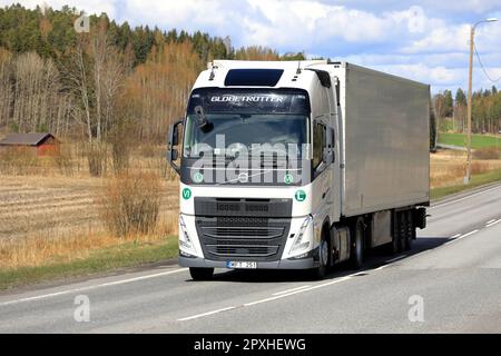 White Volvo FH truck, Globetrotter cab, pulls refrigerated semi trailer on road on a day of spring. Salo, Finland. April 27, 2023. Stock Photo