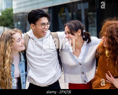 Group of young millennial friends laughing and having fun in a city Stock Photo