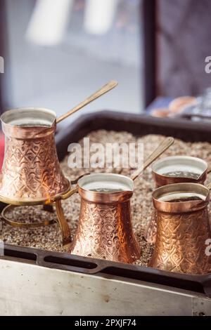 Many golden copper pots or kettles, used for making Turkish coffee. Stock Photo
