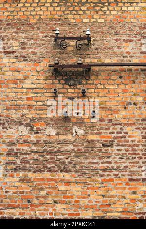 Old electrical fuses on brick wall structure as background Stock Photo