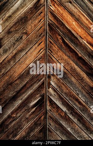 Texture of an old massive brown wooden door as background, worn wood surface Stock Photo