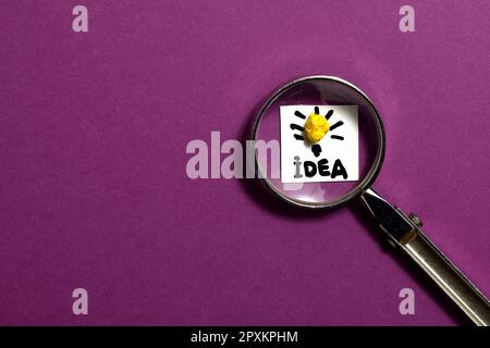 Creative idea concept, magnifying glass and light bulb icon with purple background Stock Photo