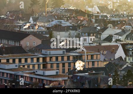 wintry roof landscape of freiburg with plumes of smoke from chimneys Stock Photo