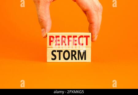 Perfect storm symbol. Concept words Perfect storm on beautiful wooden block. Beautiful orange table orange background. Businessman hand. Business and Stock Photo