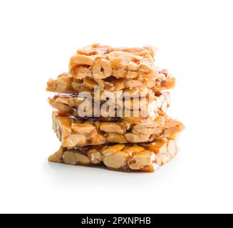 Sweet peanut brittle. Tasty peanuts in caramel isolated on the white background. Stock Photo