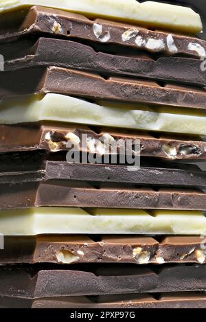 Dark, milk, hazelnut and white chocolate in a stack Stock Photo
