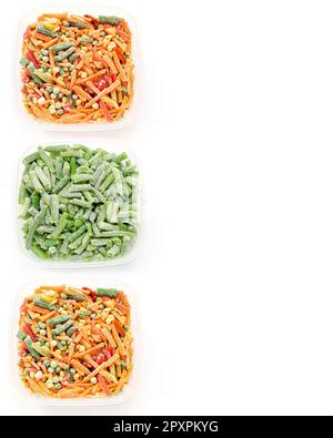 Three plastic bowls with different frozen cut vegetables on white. Green string beans, carrot, bell pepper, green peas. Freezing helps to preserve vit Stock Photo