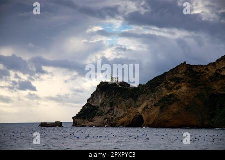Capo Miseno and its lighthouse that marks the northwestern limit of the Gulf of Naples, Italy Stock Photo