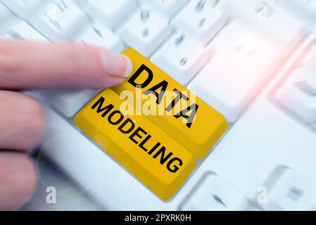 Hand writing sign Data Modeling, Business showcase process of transferring data between data storage systems Stock Photo