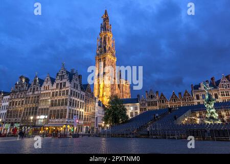 Historic Guildhalls in Grote Markt Old Town Antwerp with spire of gothic Cathedral of Our Lady, Onze lieve Vrouwe kathedraal at twilight, night. Stock Photo