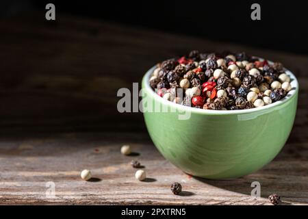Gourmet peppercorn selection. Black background. Stock Photo