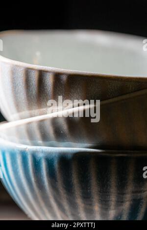 Set of three empty bowls. Dark shadows. Stock Photo