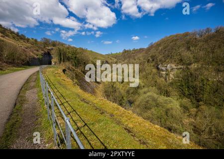 Approaching the Litton Tunnel on the Monsal Trail at Cressbrook with the river Wye below, Derbyshire, England Stock Photo