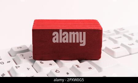 Colored cube with important message lying on keyboard. Main information. Stock Photo