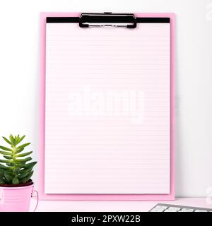 Pot with Plant and Cup Standing on Desk. Iinfrormation written on paper. Stock Photo