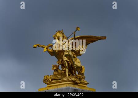 Column With The Group Of Figures 'Fama Of War' On The Bridge Pont Alexandre III Over The Seine, Paris, France, Europe Stock Photo