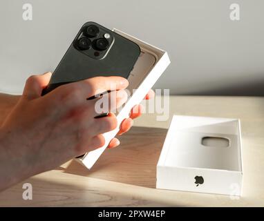 Lodz, Poland April 30 2023 Unboxing, unpacking of Apple iphone 14 pro max from box. Stock Photo