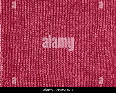 Viva Magenta color knitted Jersey as textile background. Knitted Red Magenta texture. Color of the year 2023 concept. Stock Photo