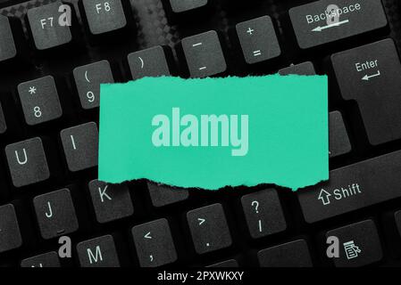 Colored sticker lying on keyboard. Important message written over paper. Stock Photo