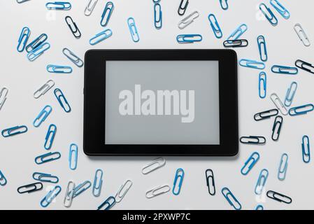 Tablet Screen With Important Ideas On It And blue and black paperclips Stock Photo