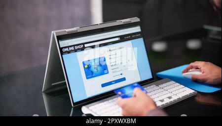 Online Payment Using Credit Card On Hybrid Laptop Stock Photo