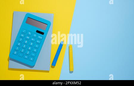 Blue notepad and markers on a blue background, top view Stock Photo