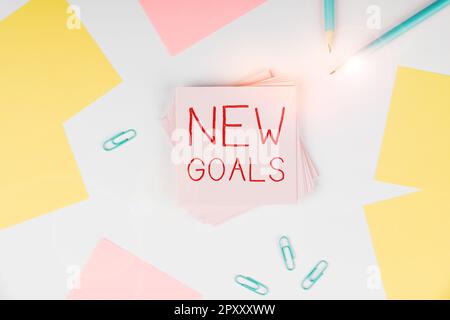 Conceptual caption New Goals, Word for a list of clearly-defined plans that a person should attain Stock Photo