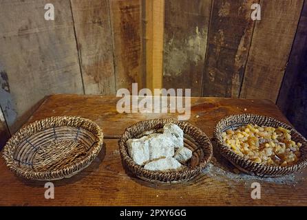 Pieces of frankincense and myrrh in wicker baskets on an old wooden table Stock Photo