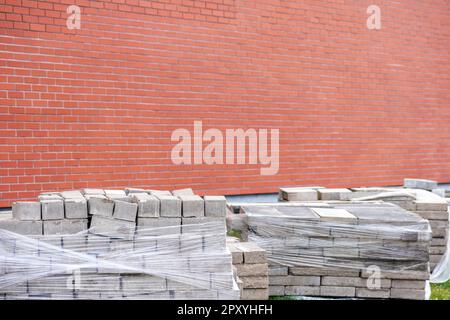 A brick wall with a brick wall and a brick wall with a sign that says brick on it. Stock Photo