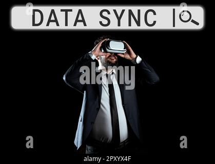 Conceptual display Data Sync, Word Written on data that is continuously generated by different sources Stock Photo