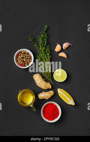 Composition of small spoons full of spices and condiments for cooking on a  black background Stock Photo - Alamy