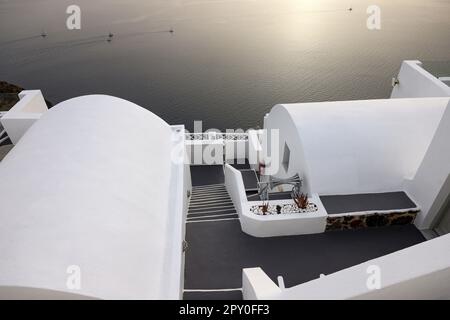 Imerovigli, Santorini, Greece - July 1, 2021: Whitewashed houses with terraces and pools and a beautiful view in Imerovigli on Santorini island, Greec Stock Photo