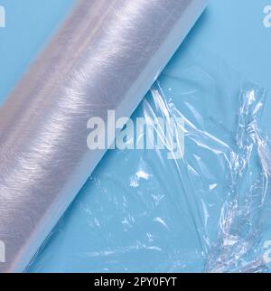 Crumpled transparent polyethylene on a blue background, top view Stock Photo