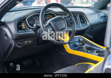 Interior of a modern Dodge charger car with the steering wheel in the center, facing the front of the vehicle Stock Photo