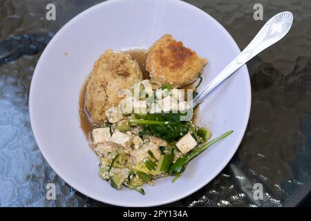 Plate with cutlets and salad on a glass table. Healthy food. A quick lunch, junk food. Stock Photo