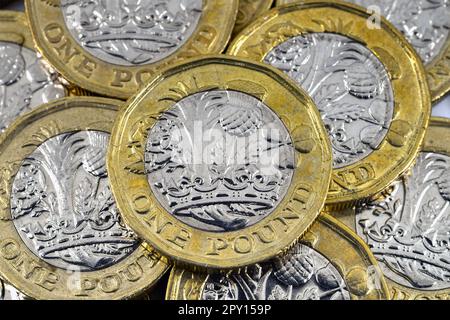 Close up view of British one pound coin on top of other coins. No people. Stock Photo