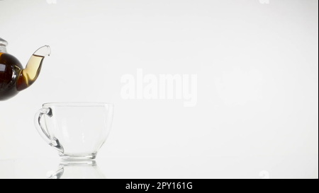 Tea Pouring. Tea Being Poured Into Glass Transparent Tea Cup. Tea