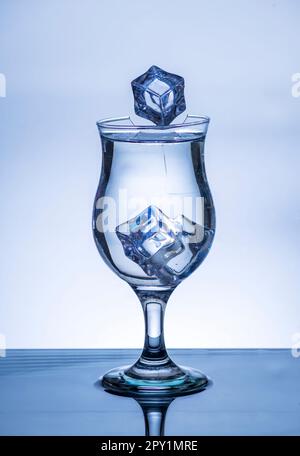 The image of pouring drinking water, into a broken glass, that makes one feel refreshed on blurred white background, Splashing water, Sparkling water, Stock Photo