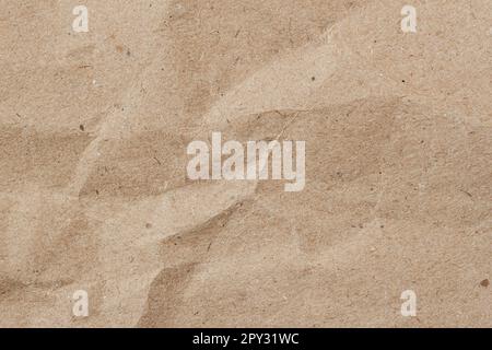 Crumpled paper with wrinkles, ecological or craft paper, brown surface texture close-up Stock Photo